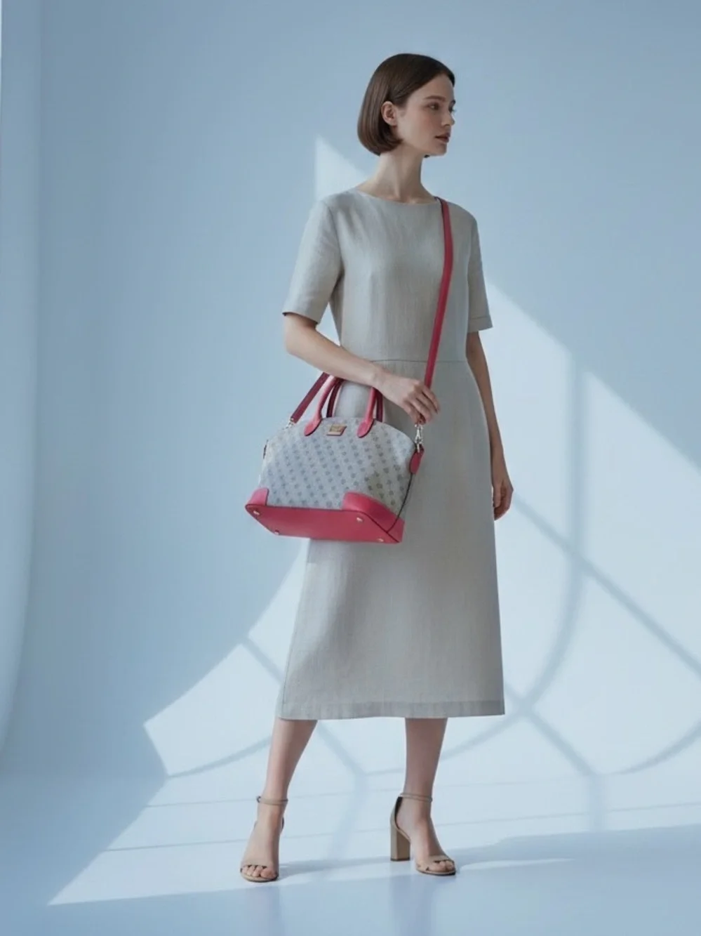 Dooney & Bourke Signature monogram satchel features vibrant pink leather trim